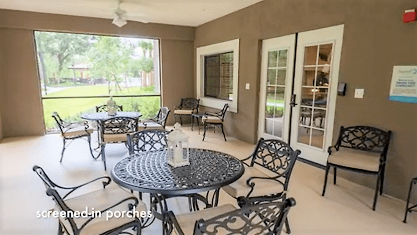 A cozy outdoor patio area with tables and chairs.