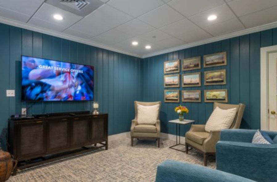 A cozy living room with comfortable seating, wall art, and a television.