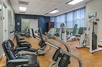 A modern gym with various exercise machines and equipment.