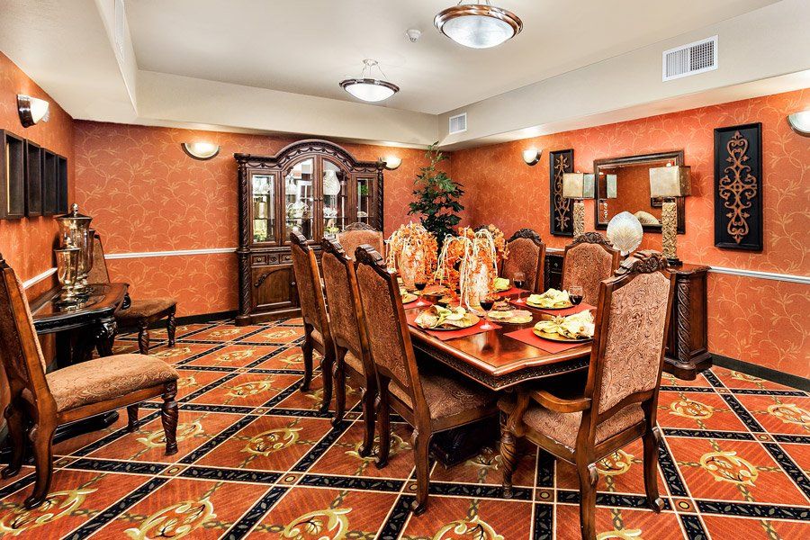 A luxurious dining room with an ornate table set and elegant decor.