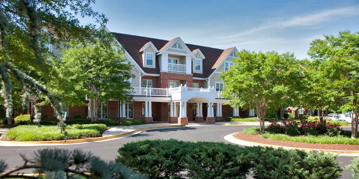 A beautiful residential building with classic architecture and well-maintained landscaping.