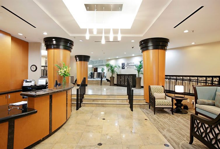 A modern hotel lobby with a reception desk and comfortable seating.
