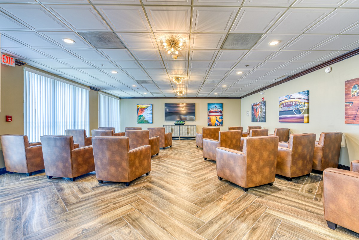 A spacious and modern conference room with comfortable seating and art-adorned walls.