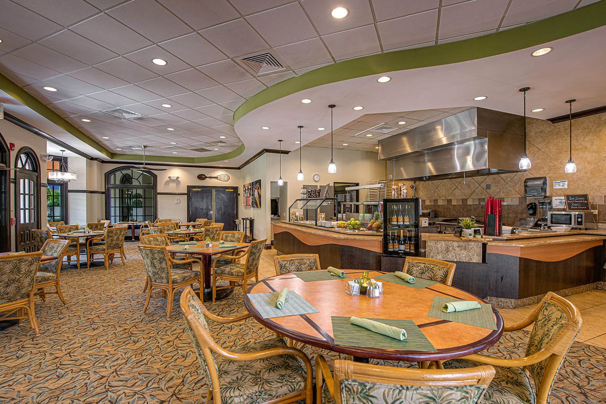 A modern and inviting dining area with neatly arranged tables and chairs, featuring contemporary decor.