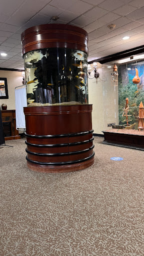 A stylish round aquarium integrated into an elegant interior space.