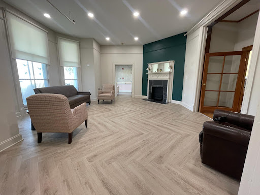 A modern living room featuring an inviting layout with stylish furniture and beautiful laminate flooring.