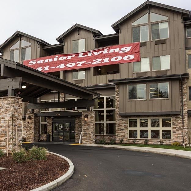 A senior living facility with a prominent entrance and banner.