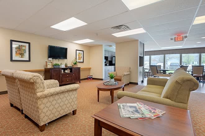 A cozy and well-lit communal lounge area with comfortable seating and modern decor.