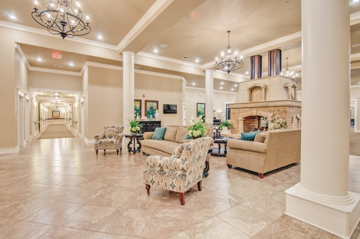 A spacious and elegantly decorated hotel lobby with comfortable seating and chandeliers.