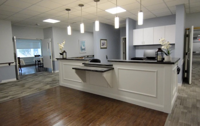 A modern office reception area with a clean and minimalist design.