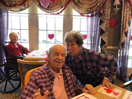 Two friends enjoying a cheerful moment together during a Valentine's Day celebration.