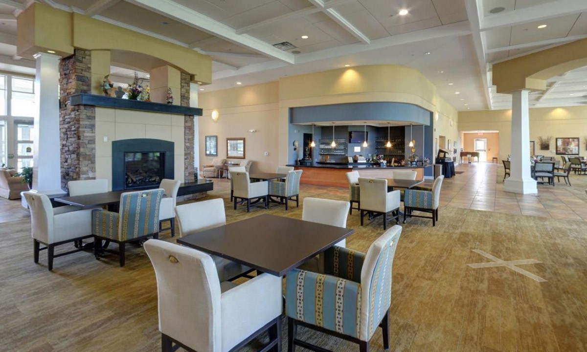A modern dining area with elegant furniture and soft lighting.