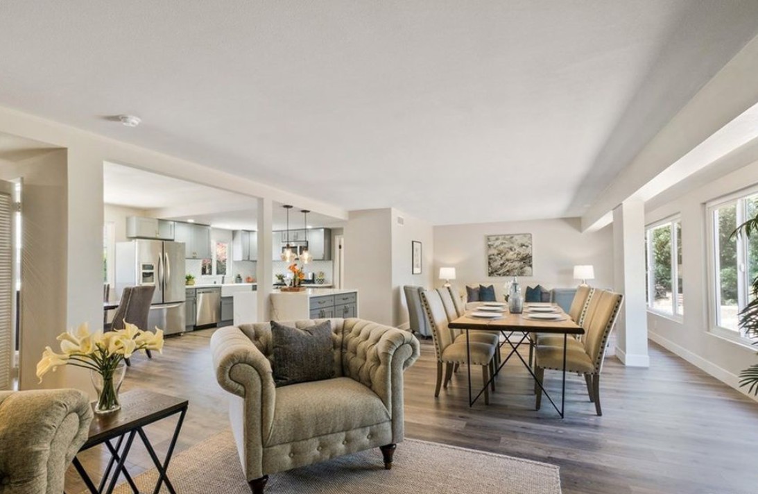 A spacious, modern open-plan living and dining area with elegant furnishings and a cozy ambiance.