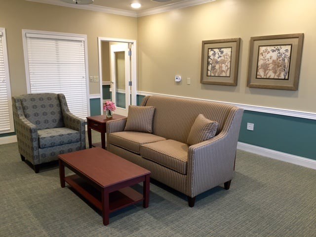 A cozy living room with a sofa, chair, and coffee table.