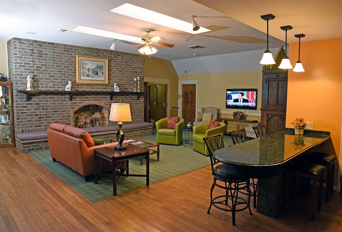 A cozy living room with a fireplace, television, and comfortable seating.