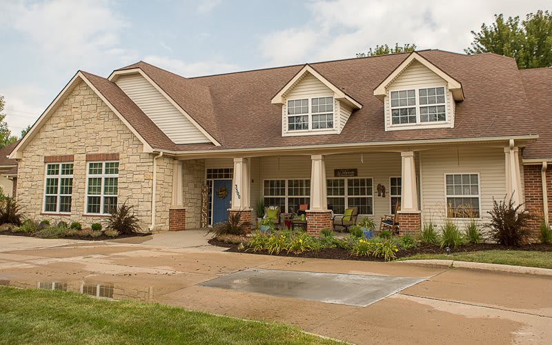 A suburban residential house with a manicured front yard and driveway.