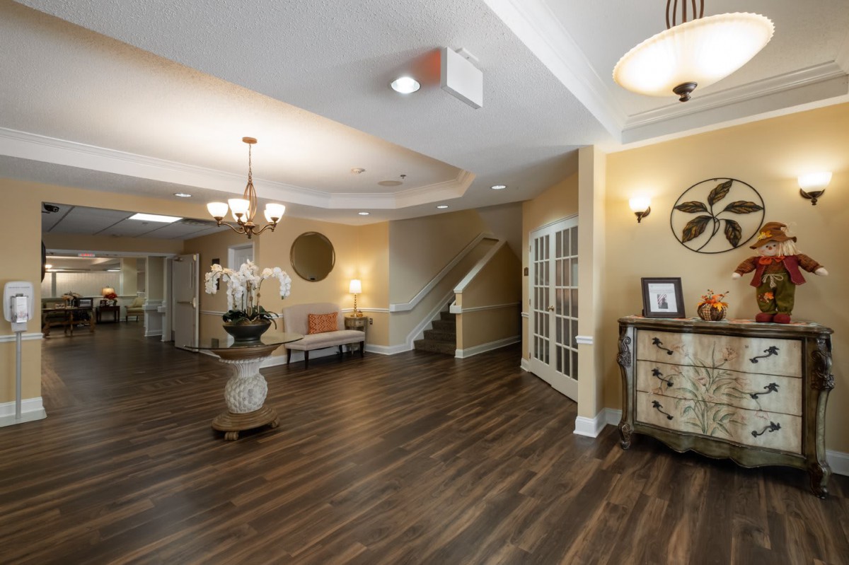 A spacious lobby area with elegant decor and a central staircase.