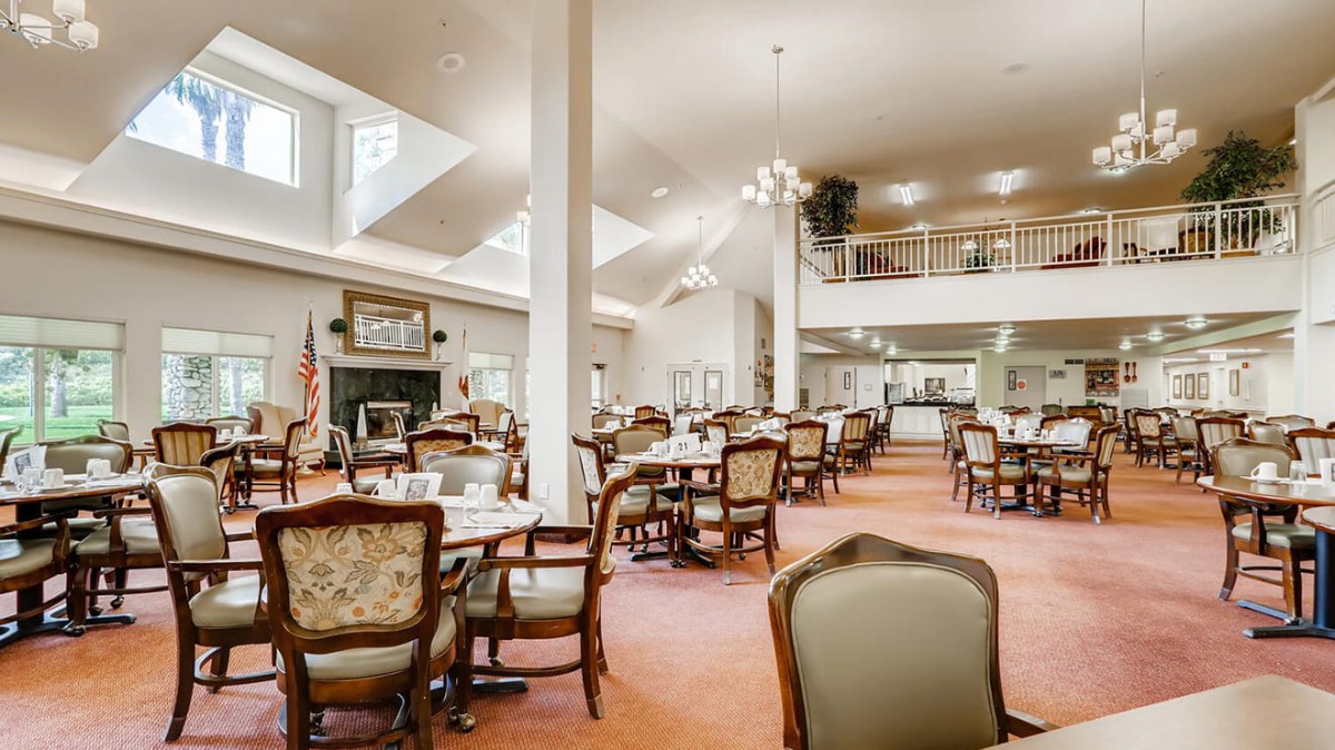 A spacious dining area with elegant furniture and skylights.
