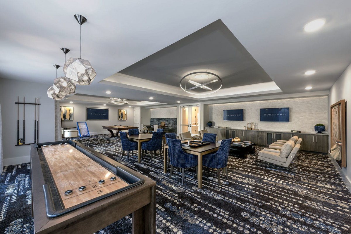 A modern lounge area with stylish furniture and lighting.