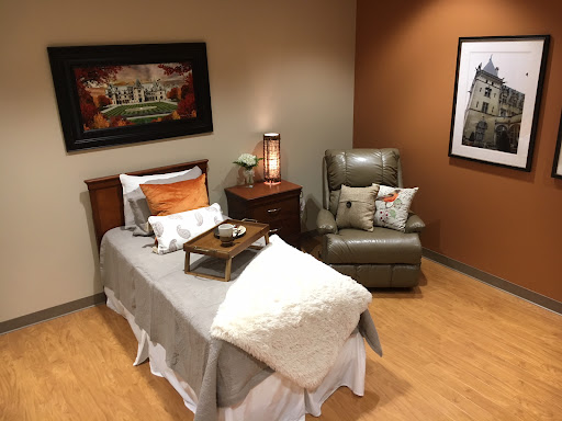 A cozy and well-decorated bedroom featuring a comfortable bed and inviting seating area.