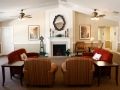 A cozy living room featuring a fireplace, sofas, and warm lighting.