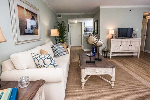 A beautifully designed living room featuring light-colored walls, comfortable seating, and stylish decor elements.
