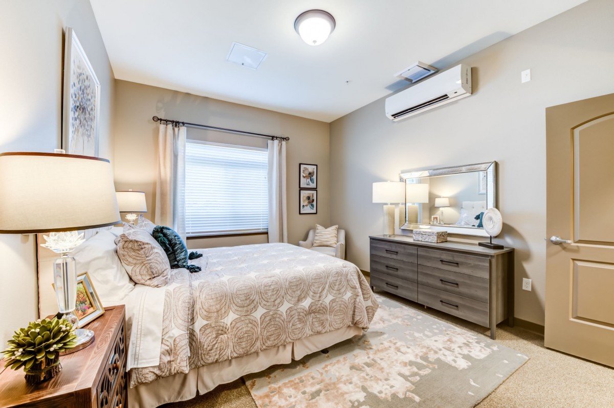 A cozy bedroom featuring a comfortable bed, stylish dresser, and elegant decor with soft lighting.