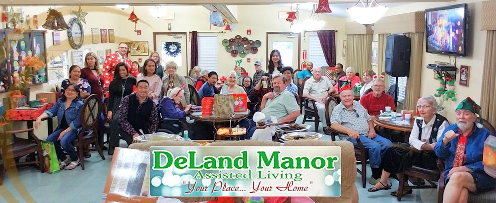 Residents and staff at DeLand Manor Assisted Living enjoy a festive gathering surrounded by holiday decorations.