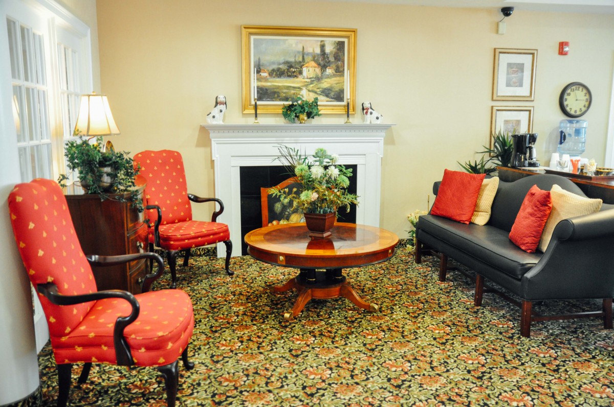 A classic living room with elegant furniture and a cozy fireplace.