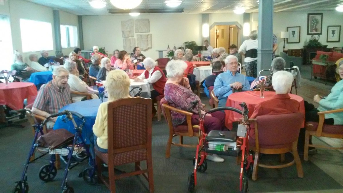 A group of elderly people socializing in a community center.