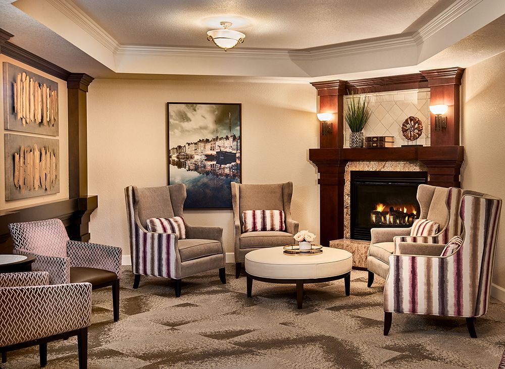 A cozy living room featuring stylish armchairs and a fireplace.