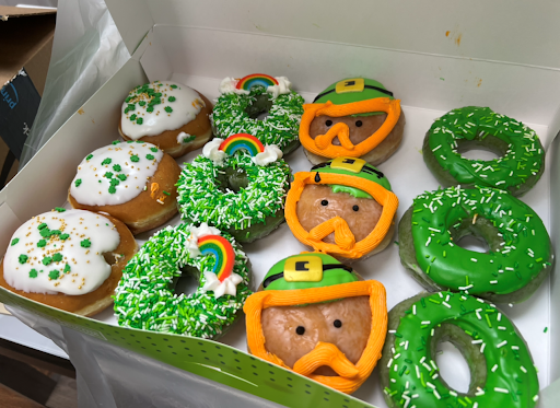 A delightful assortment of St. Patrick's Day themed donuts featuring green icing, shamrocks, and leprechaun designs.