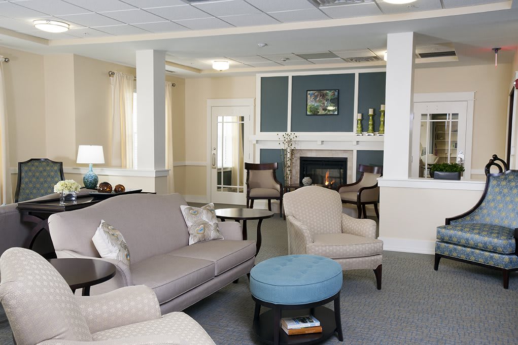 A cozy living room with sofas, a coffee table, and a fireplace.