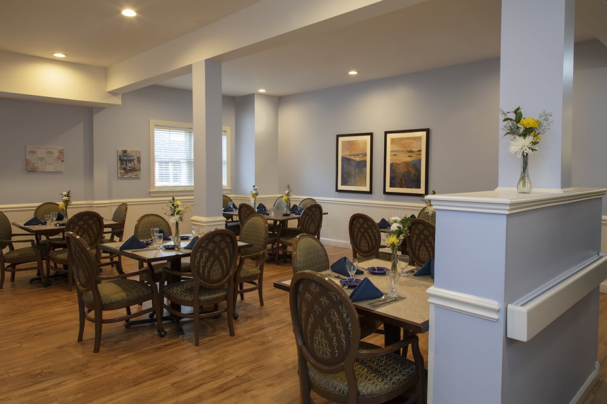 A cozy dining room with elegant furniture and warm lighting.