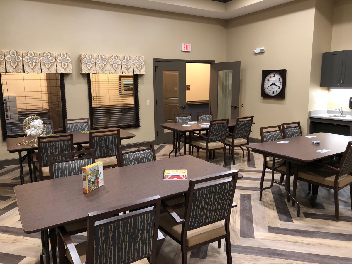 An empty dining area with arranged tables and chairs.