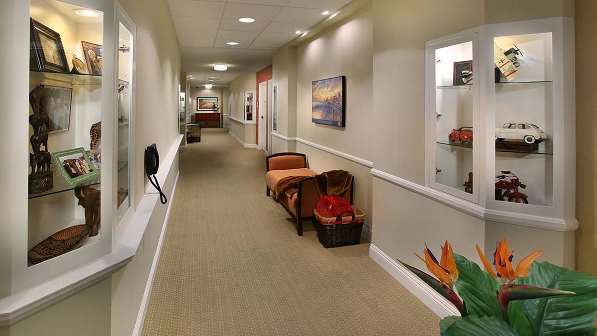 A well-decorated hallway with seating and artwork on the walls.