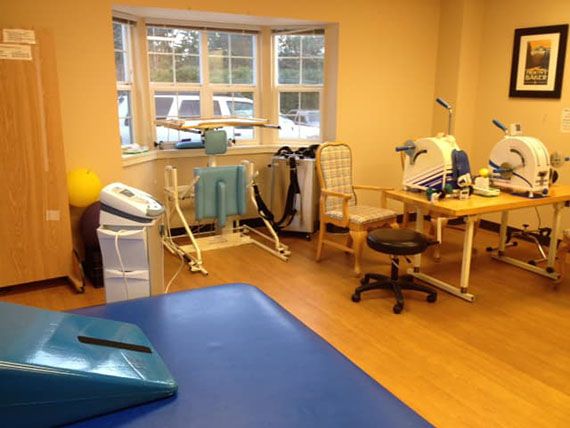 A physical therapy room equipped with various rehabilitation tools and machines.