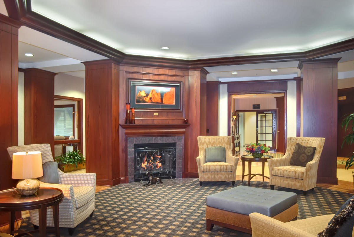 A cozy hotel lobby with a fireplace and comfortable seating area.