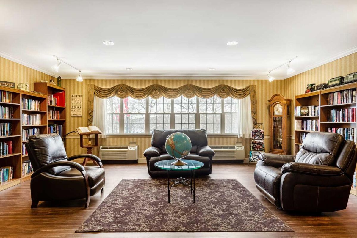 A cozy living room with leather seating and a central globe.
