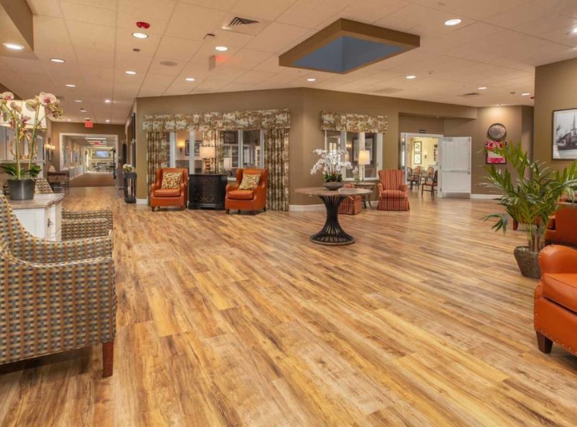 A modern lobby with wood flooring and comfortable seating areas.