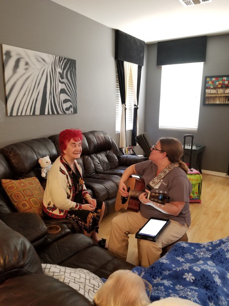 Two people enjoying a music session in the living room.