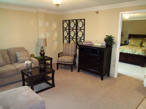 A cozy living room with comfortable seating, decorative elements, and soft lighting.