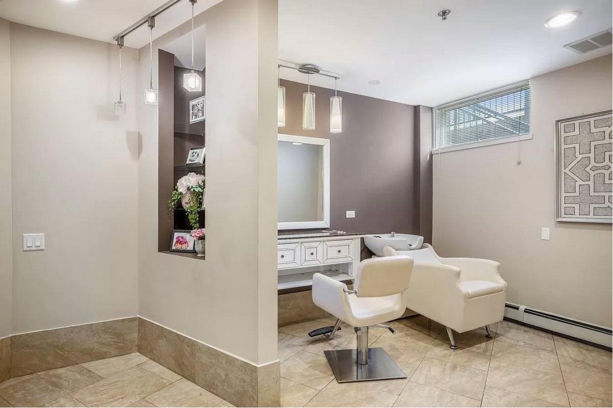 A modern salon interior with stylish furniture and bright lighting.