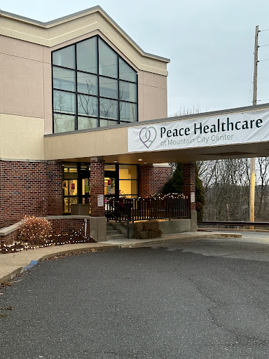 Entrance of Peace Healthcare facility with a prominent exterior sign.
