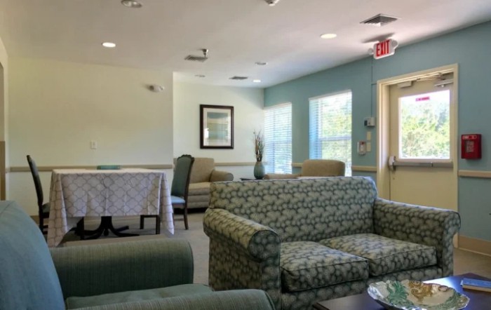 A cozy and well-lit waiting area with sofas and chairs.