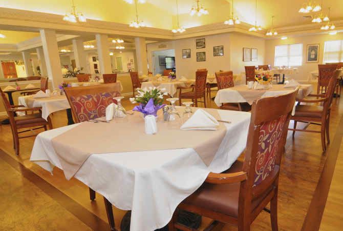 An elegantly set dining area in a restaurant, featuring well-decorated tables and comfortable seating.