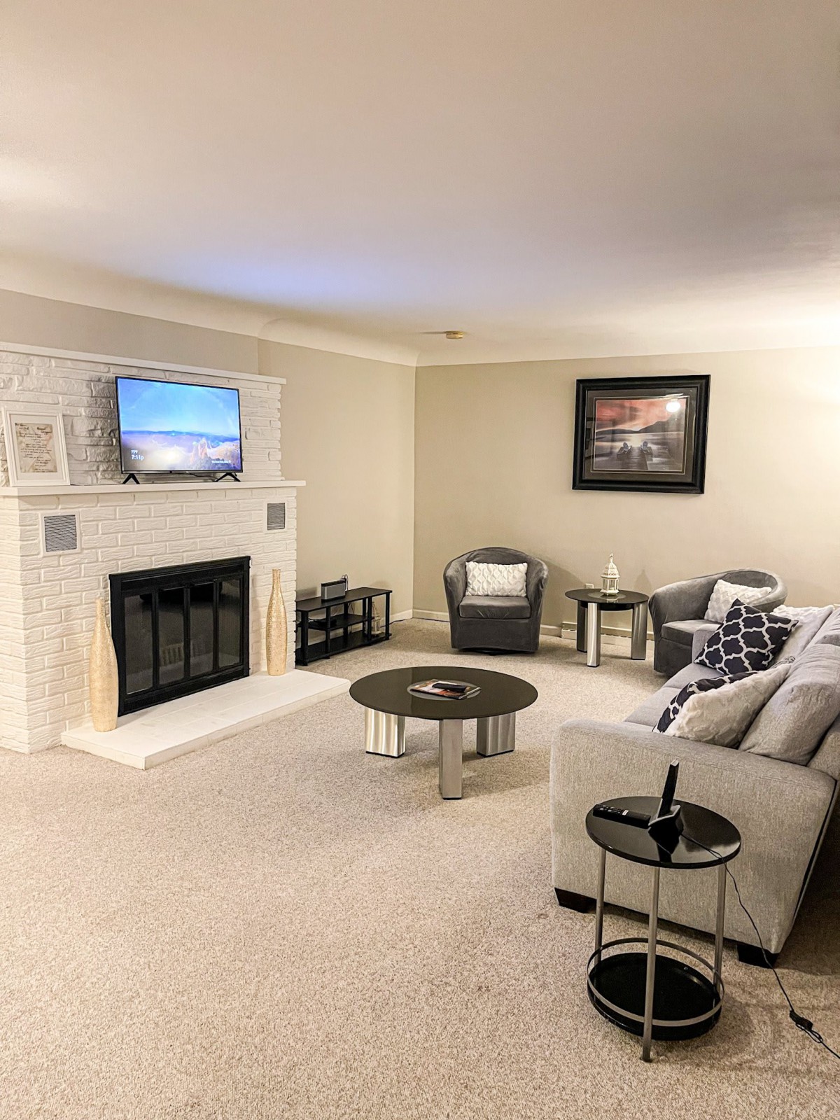 A cozy living room with a fireplace, TV, and comfortable seating.