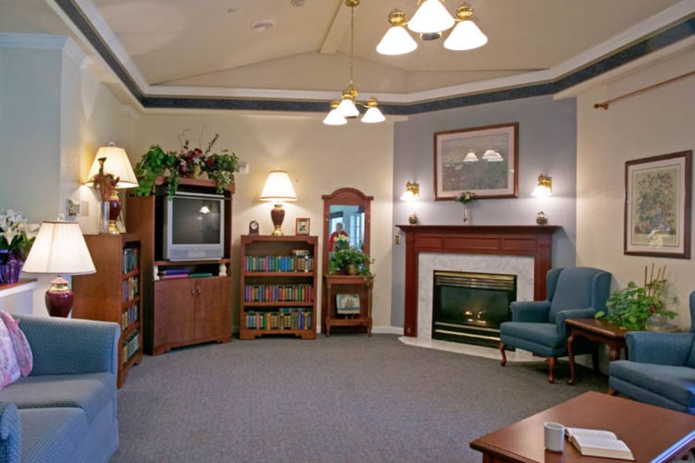A cozy living room with a fireplace, TV, and comfortable seating.