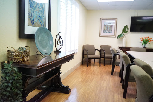 A serene waiting room featuring elegant furniture and decorative art.