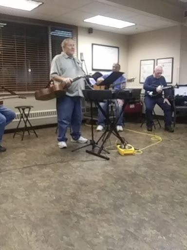 A group of musicians performing together in a casual setting.